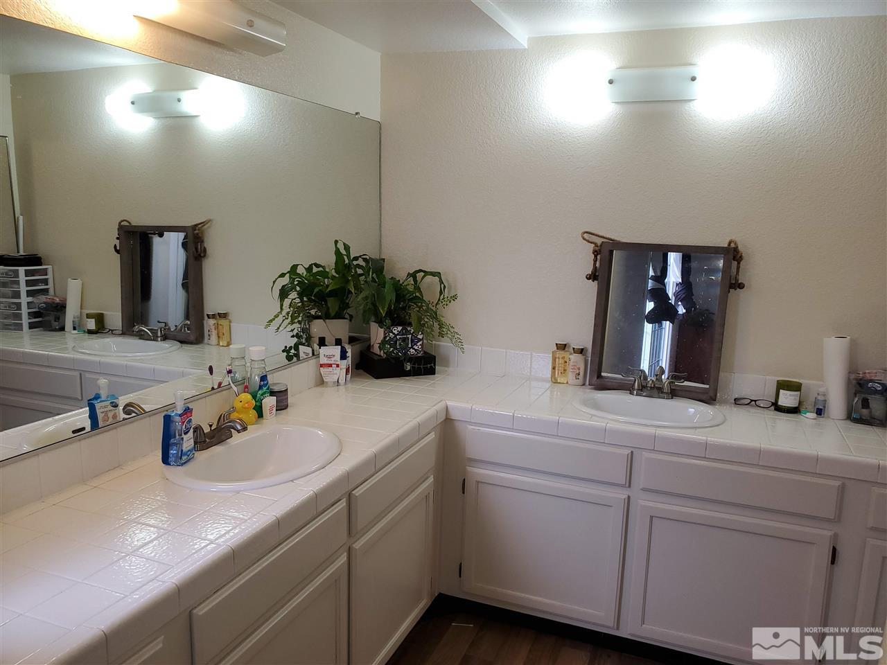6940 Flower Street Reno, NV 89506 - Photo 11 of 20 a bathroom with a sink and a mirror