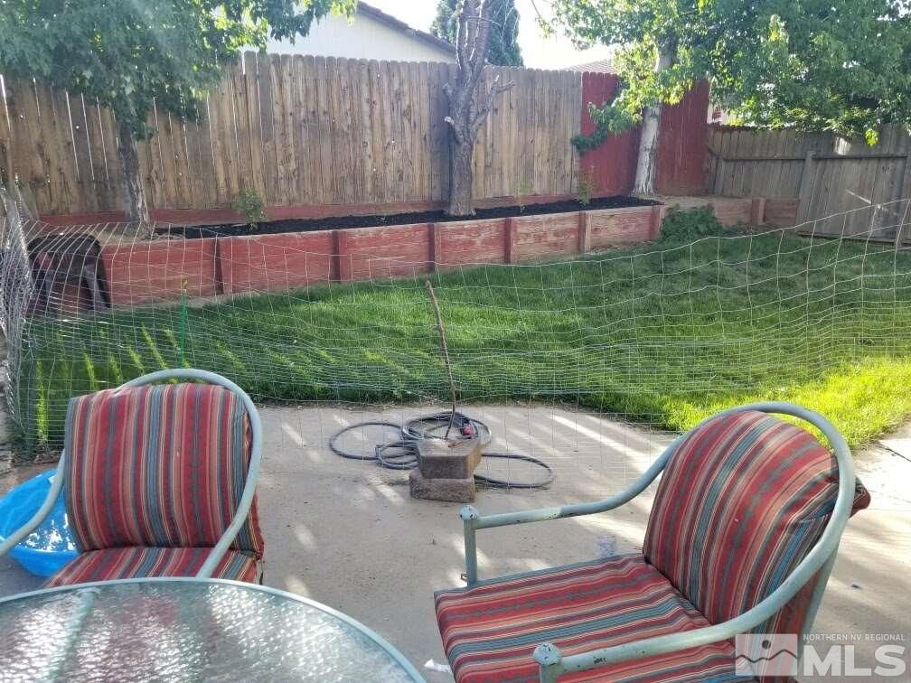 6940 Flower Street Reno, NV 89506 - Photo 18 of 20 a view of backyard with outdoor seating and green space