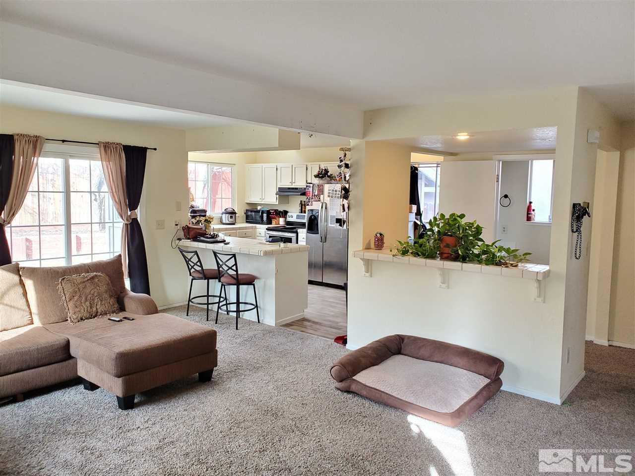 6940 Flower Street Reno, NV 89506 - Photo 5 of 20 a living room with furniture and a large window