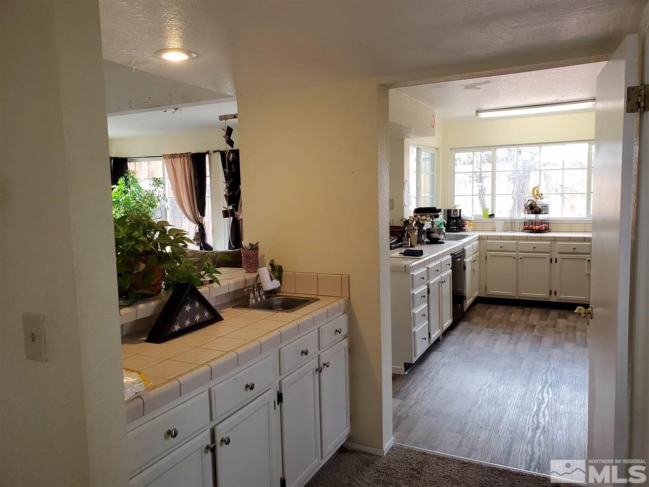 6940 Flower Street Reno, NV 89506 - Photo 7 of 20 a kitchen with a sink stove and cabinets