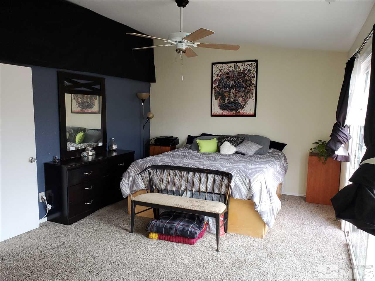 6940 Flower Street Reno, NV 89506 - Photo 9 of 20 a bedroom with a bed and a chandelier