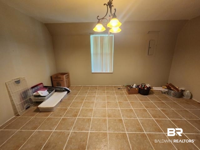 32749 Antietam Road Lillian, AL 36549 - Photo 9 of 47 Interior space with tile patterned flooring, a notable chandelier, and vaulted ceiling