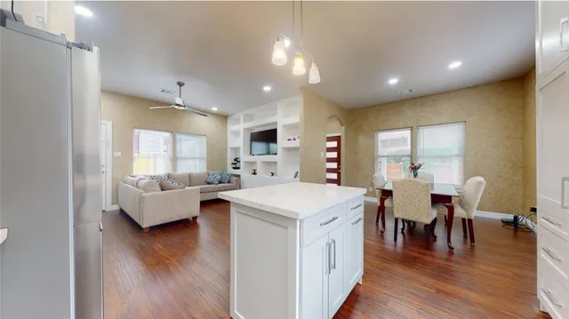 a view of living room with granite countertop furniture and a wooden floor
