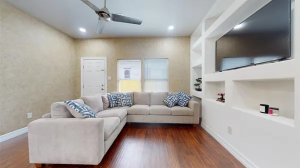 a living room with furniture and a flat screen tv