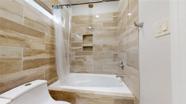 a bathroom with a bathtub and a shower