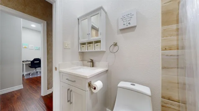 a bathroom with a sink toilet and shower