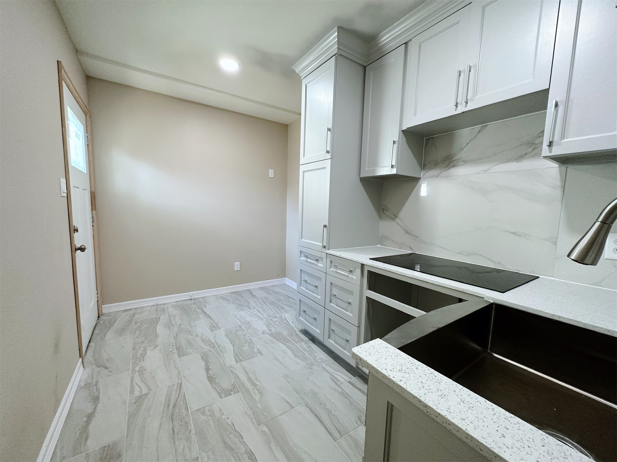 426 Middle Street Houston, TX 77003 - Photo 31 of 38 a view of an empty room with wooden floor and cabinets