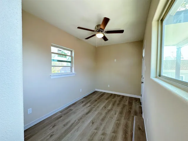 wooden floor in an empty room with a window