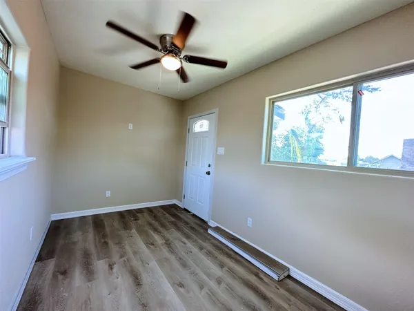 wooden floor in an empty room with a window