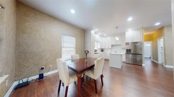 a view of a dining room with furniture and wooden floor