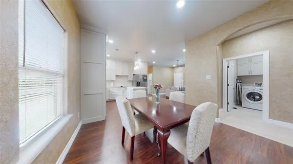 a view of a dining room with furniture and wooden floor