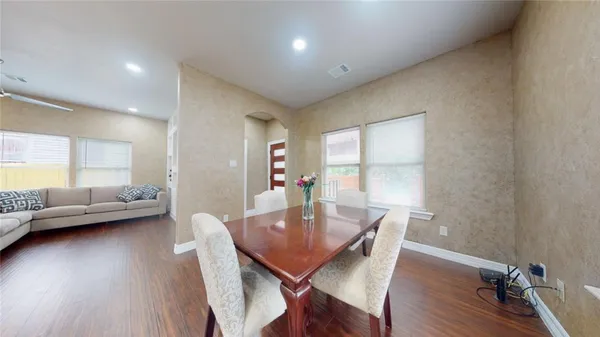 a view of a dining room with furniture and wooden floor