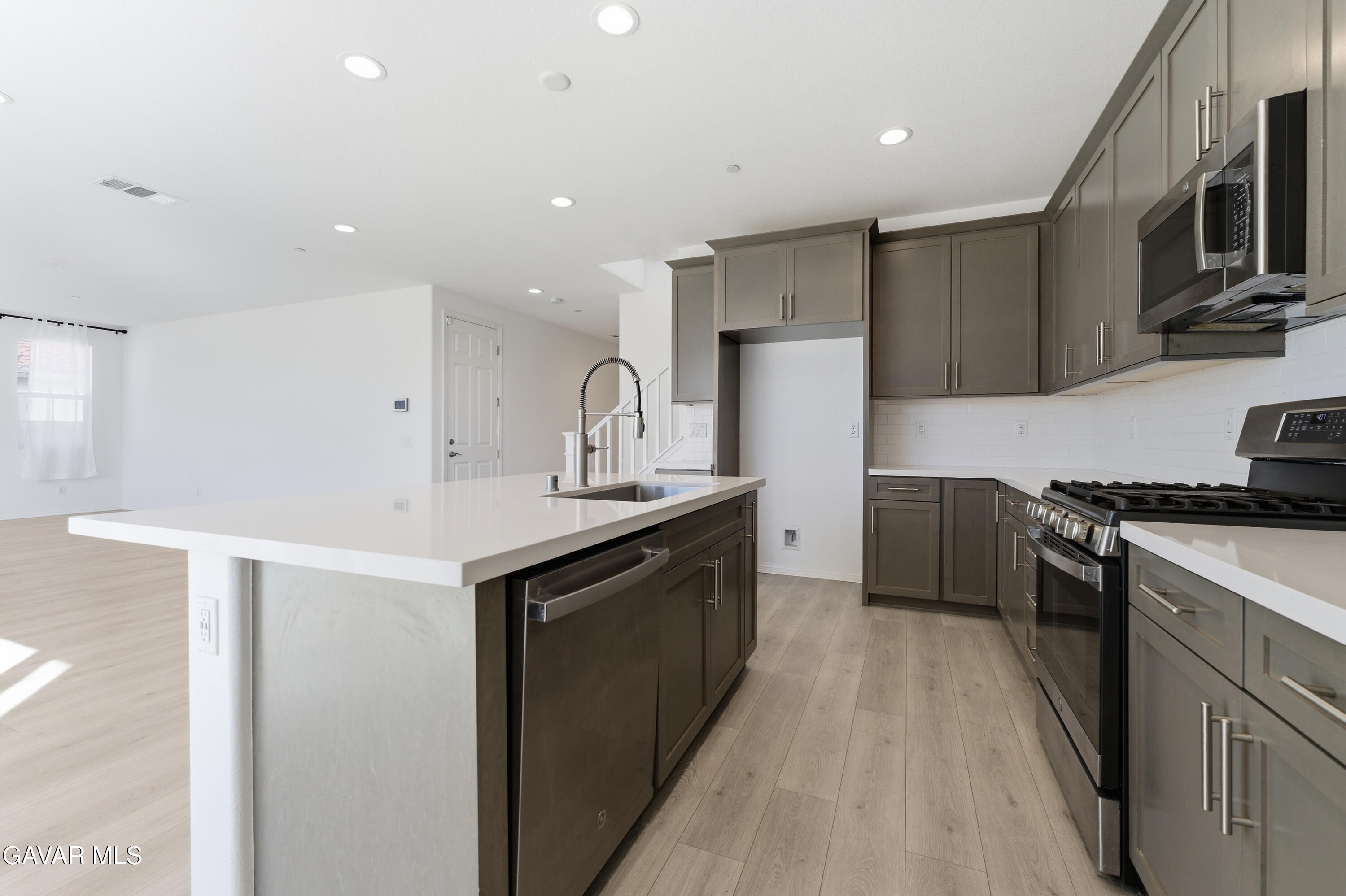 43869 Hampton Street Lancaster, CA 93536 - Photo 3 of 20 a kitchen with stainless steel appliances a sink stove and refrigerator
