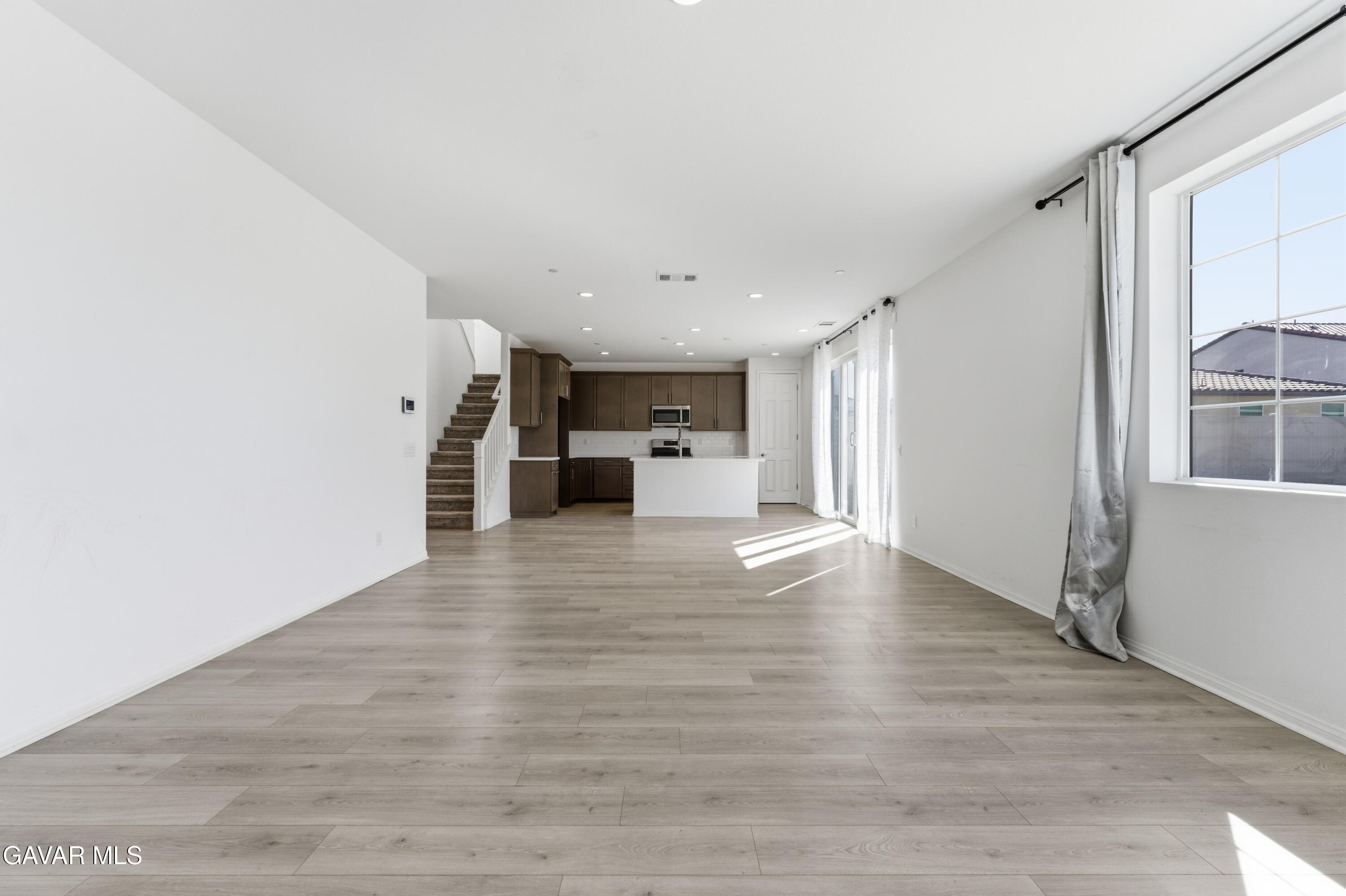 43869 Hampton Street Lancaster, CA 93536 - Photo 7 of 20 a view of kitchen with furniture and wooden floor