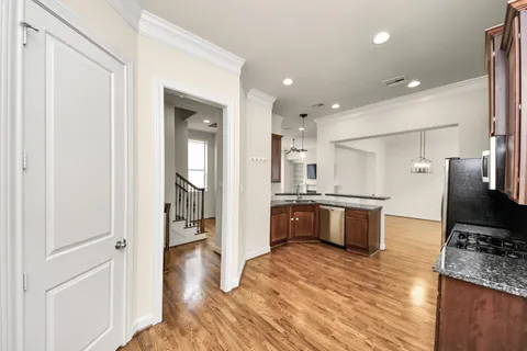 a large kitchen with stainless steel appliances kitchen island granite countertop a large counter top and stove