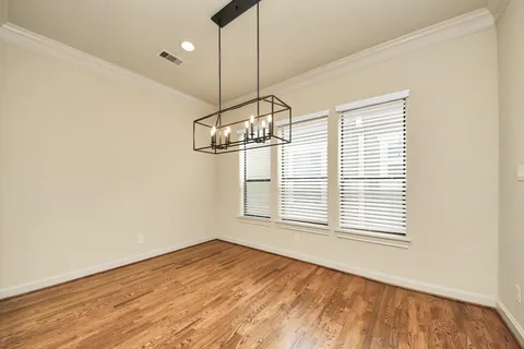 a view of a room with a window and wooden floor