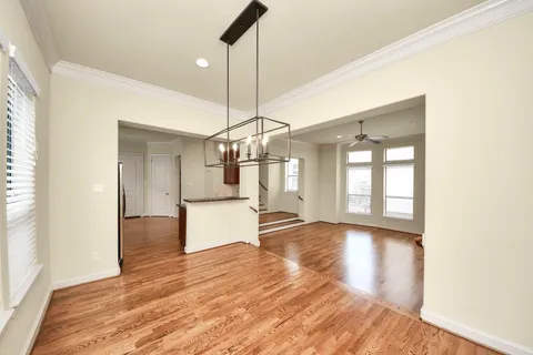 a view of a room with wooden floor and windows