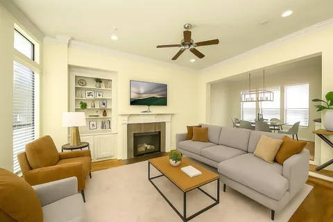a living room with furniture a flat screen tv and a fireplace