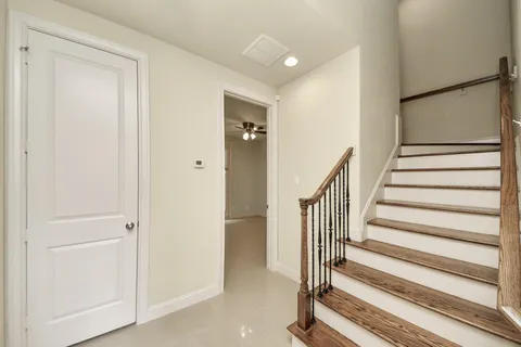 a view of entryway with wooden floor and stairs
