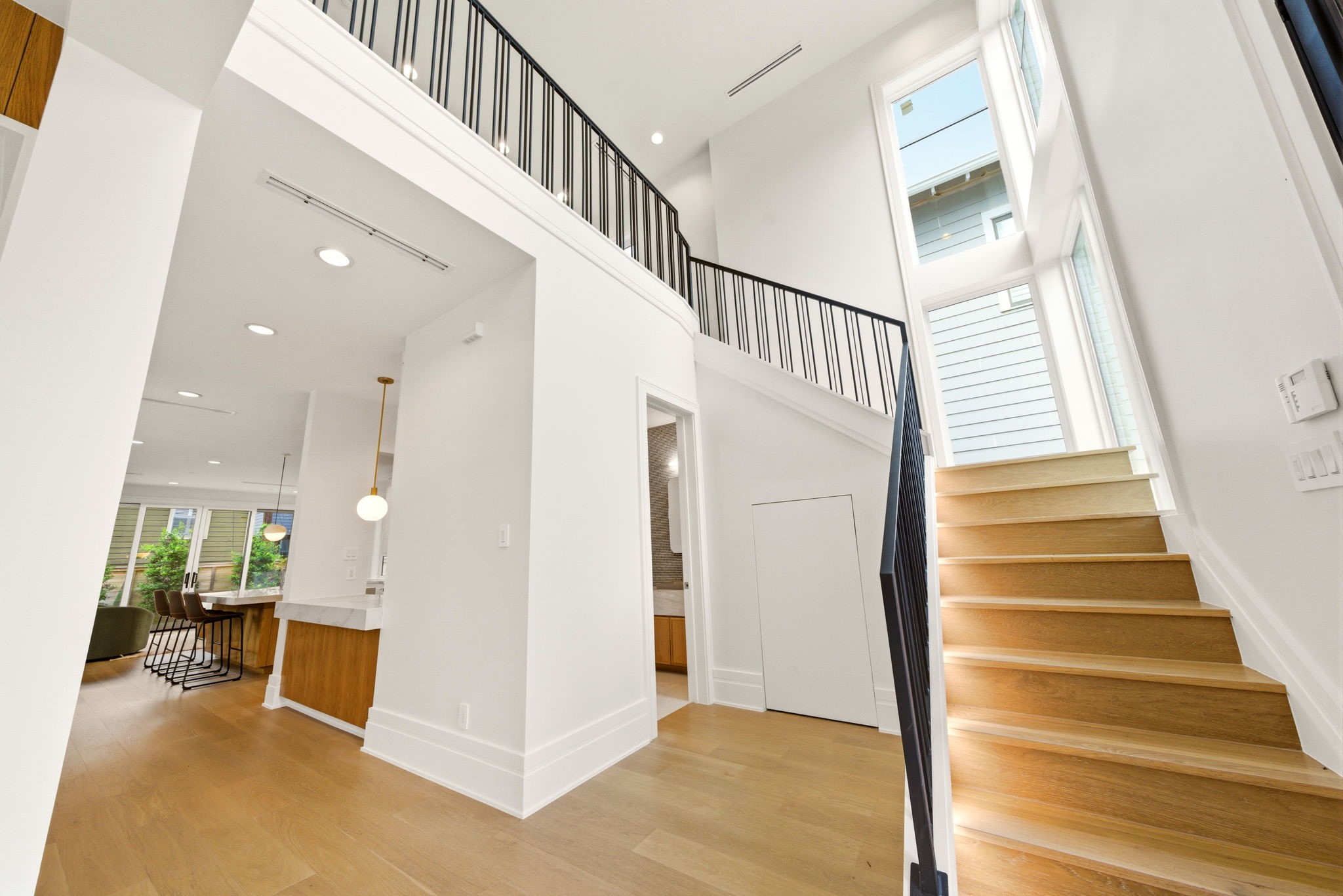 1023 Euclid Street Houston, TX 77009 - Photo 11 of 50 Dramatic two-story foyer filled with natural light, soaring ceilings, and stunning lit staircase.