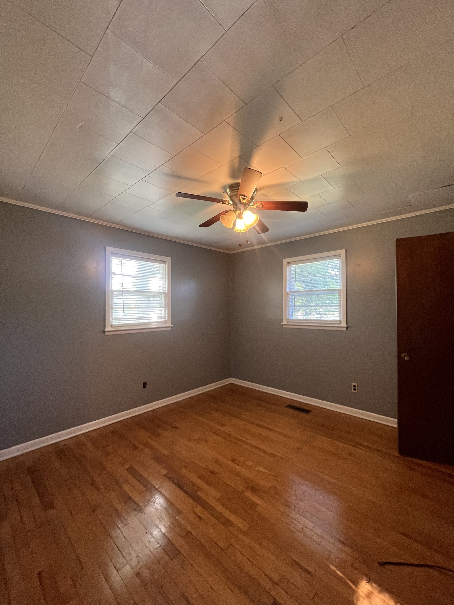 1035 North 3rd Street Pulaski, TN 38478 - Photo 13 of 17 an empty room with wooden floor fan and windows