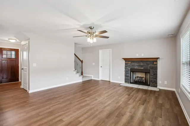 wooden floor fireplace and windows in an empty room