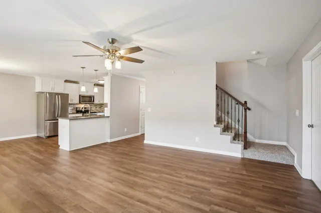 a view of kitchen with stainless steel appliances a refrigerator and a ceiling fan