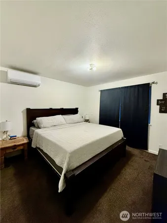 a bedroom with a bed and a night stand