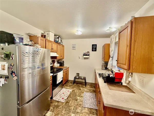 a kitchen with refrigerator and window
