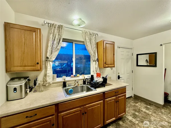 a kitchen with a sink and a refrigerator