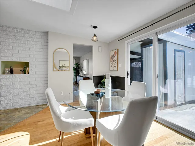 a dining room with furniture and wooden floor