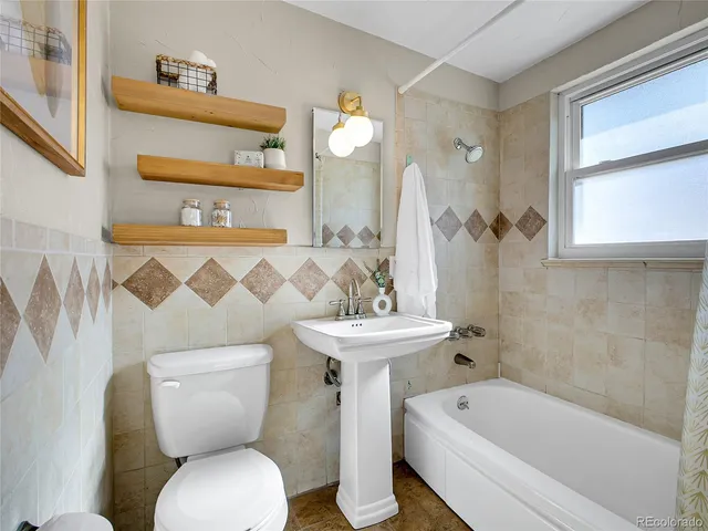 a bathroom with a sink a toilet and a bathtub