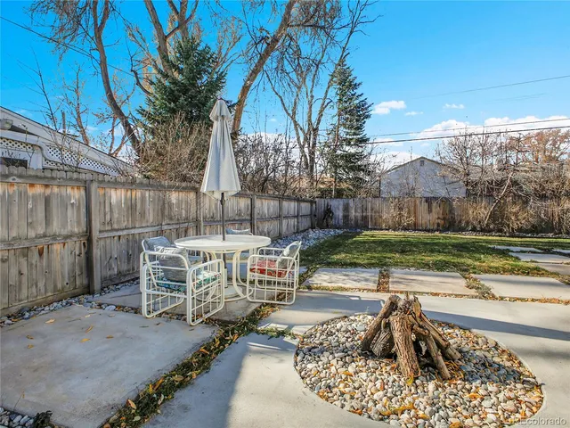 a view of a backyard with sitting area
