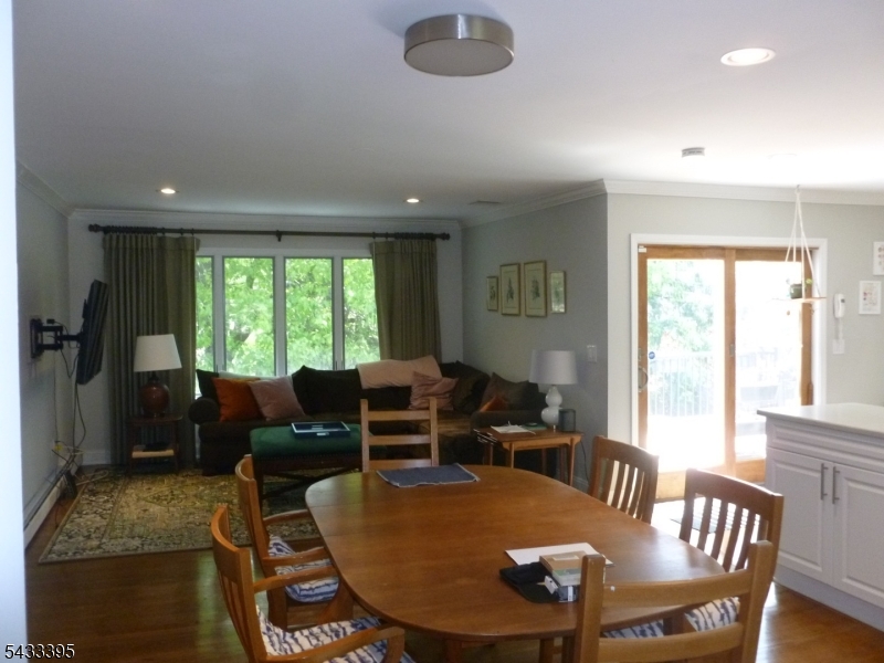48 Woodmont Road Montclair, NJ 07043 - Photo 5 of 20 a living room with furniture a large window and a dining table