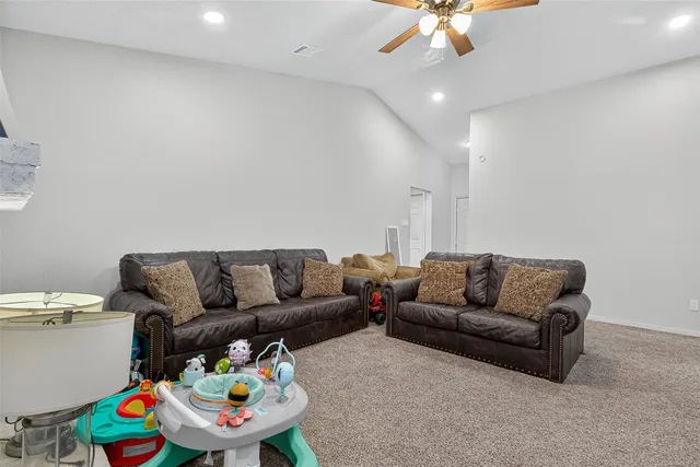 a living room with furniture and a chandelier