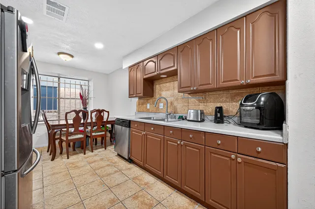 a kitchen with sink cabinets and window