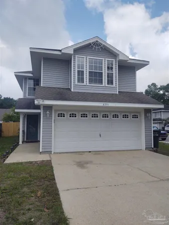 a front view of a house with garage
