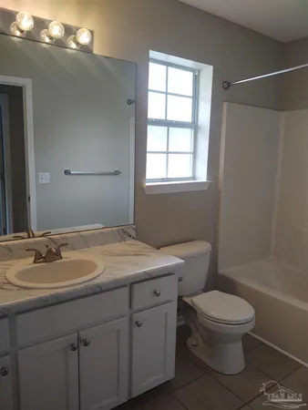 a view of an house with backyard and a garden