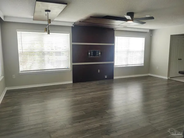 a bathroom with a granite countertop toilet and a sink