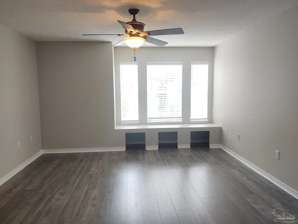 a bathroom with a granite countertop sink a toilet and bathtub