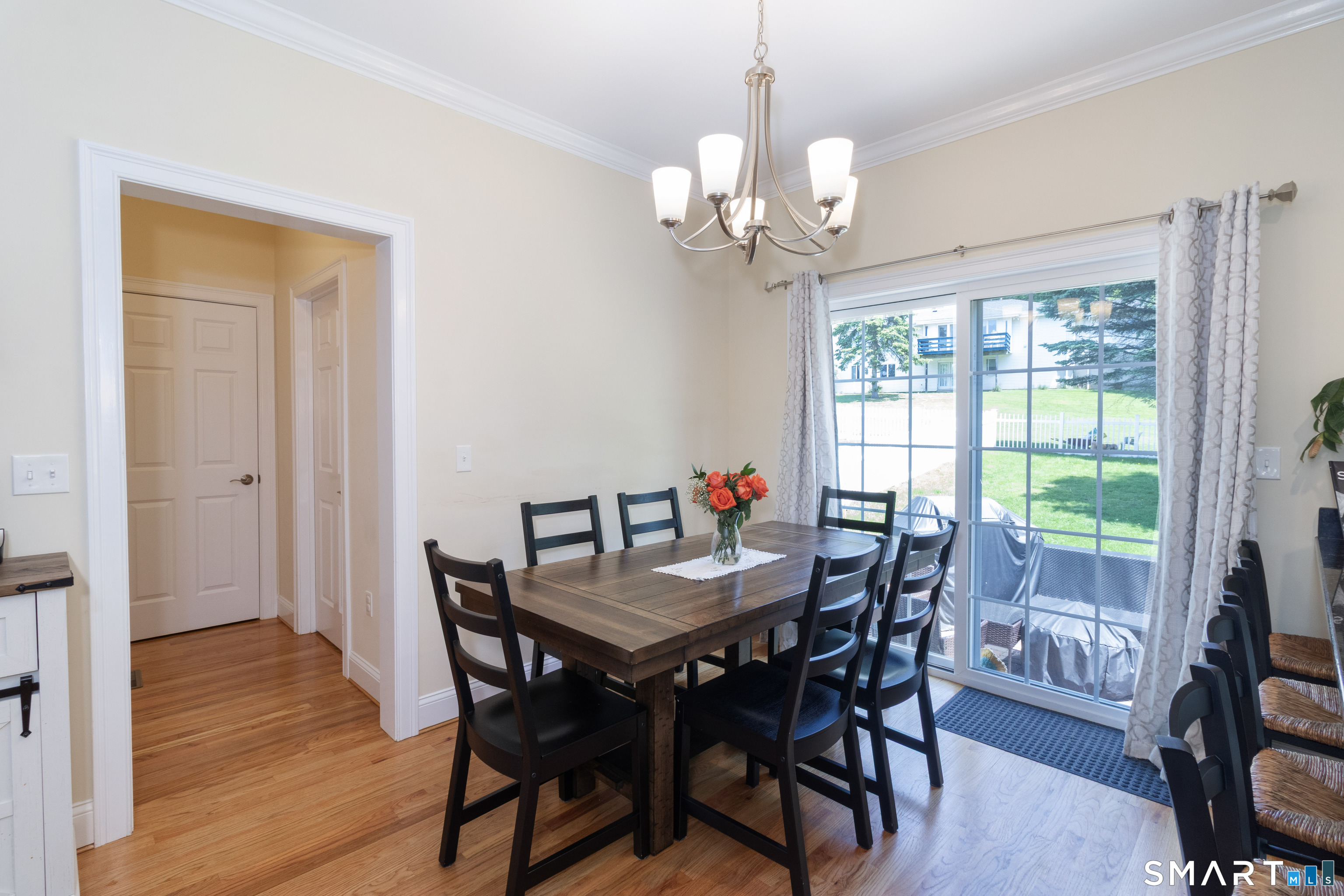 656 Bartholomew Road, Unit 656 Middletown, CT 06457 - Photo 15 of 27 a view of a dining room with furniture window and wooden floor