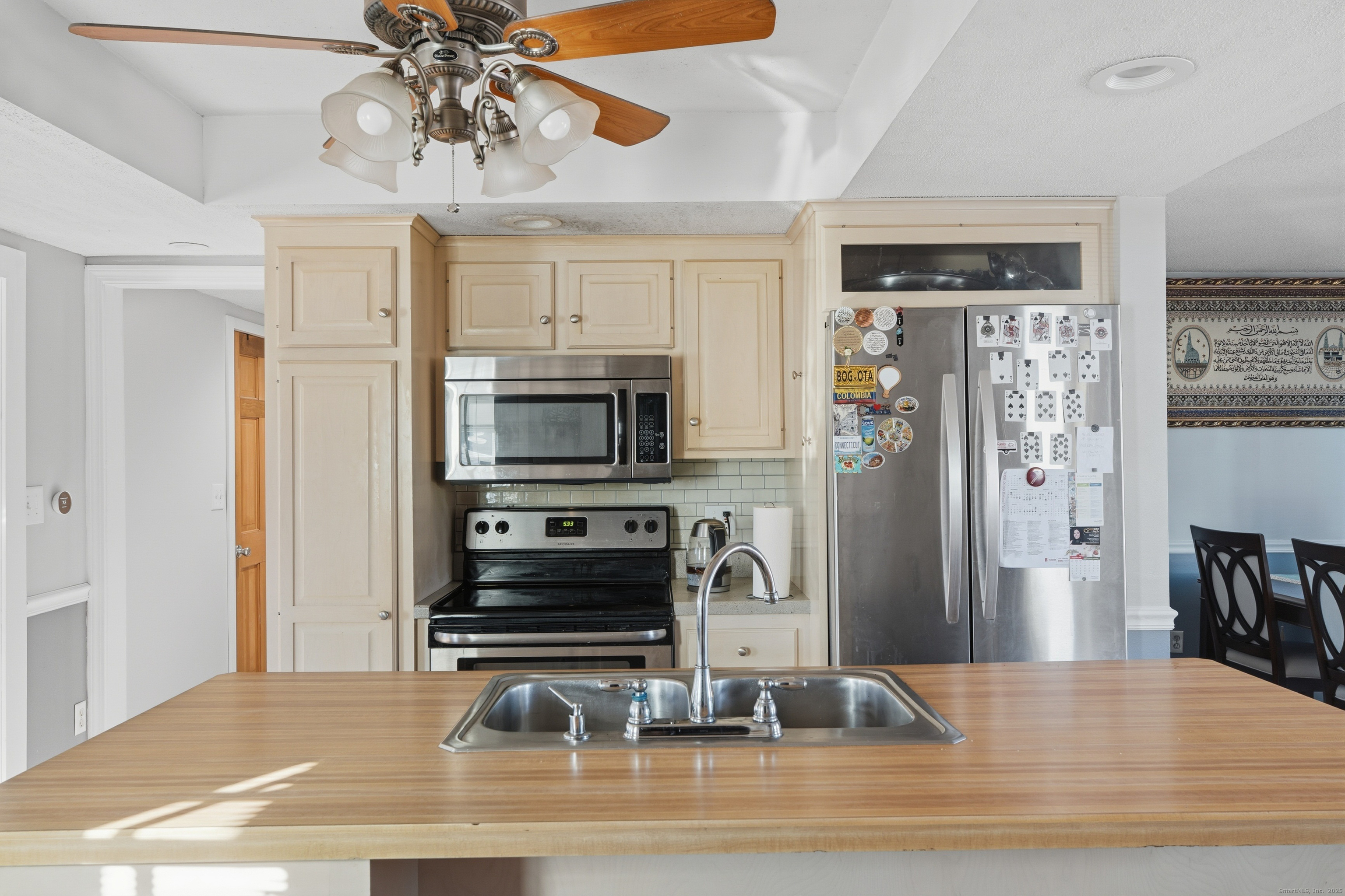 103 Benham Street Bristol, CT 06010 - Photo 11 of 39 a kitchen with stainless steel appliances granite countertop a refrigerator a stove and a sink with granite countertops