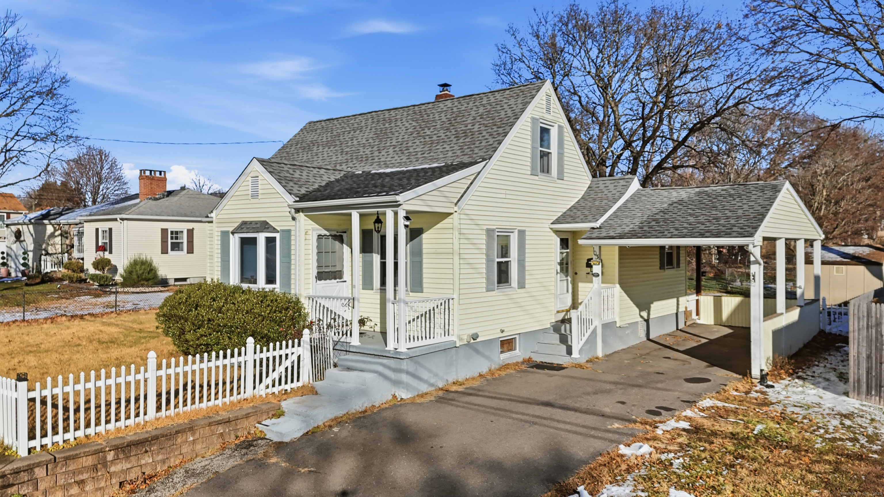 103 Benham Street Bristol, CT 06010 - Photo 3 of 39 a view of a house with wooden fence next to a house