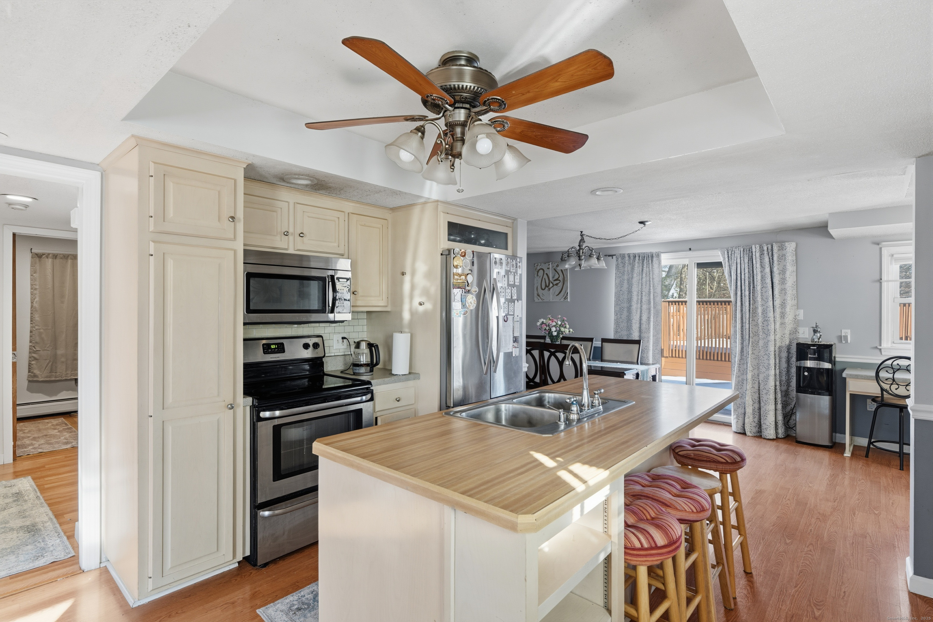 103 Benham Street Bristol, CT 06010 - Photo 10 of 39 a kitchen with stainless steel appliances kitchen island granite countertop a refrigerator a stove a sink a dining table and chairs with wooden floor