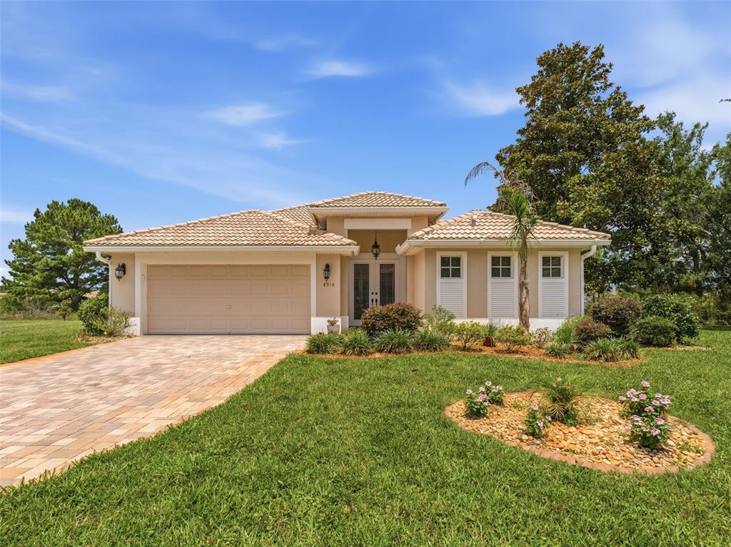 8910 Jericho Road Weeki Wachee, FL 34613 - Photo 1 of 52 a front view of a house with a garden and yard