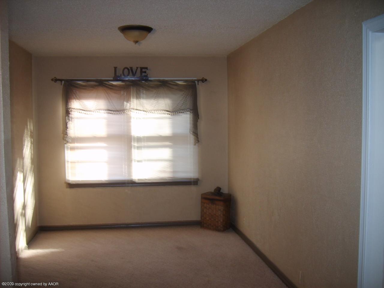 4011 South Jackson Street Amarillo, TX 79110 - Photo 9 of 10 a room with a window and a refrigerator