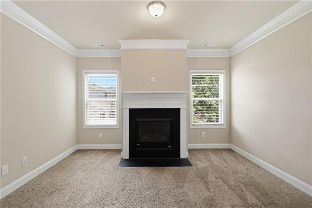 114 Madison Street Canton, GA 30115 - Photo 11 of 39 a living room with a fireplace and a window