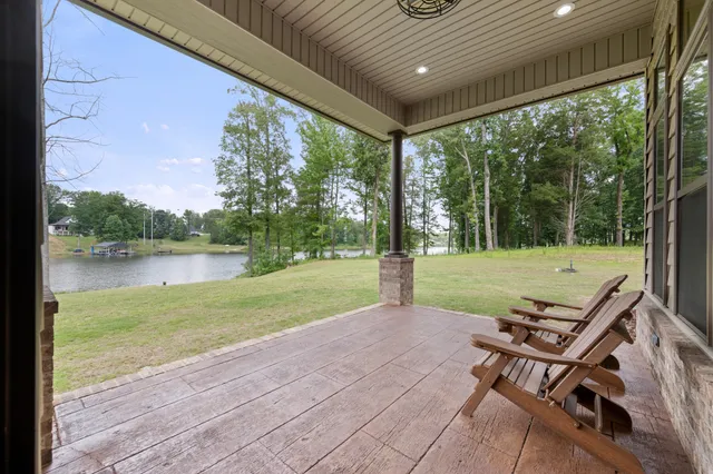 a living room with furniture and large windows