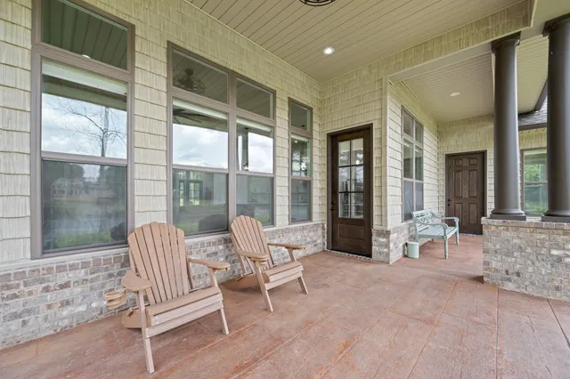 a patio with yard glass top table and chairs