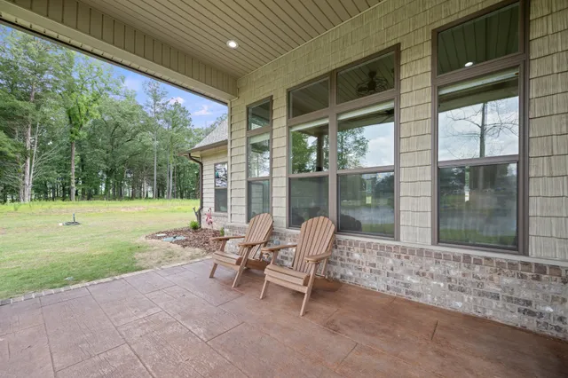 a view of a patio with a table chairs and a backyard
